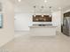 This modern kitchen features a granite island, dark wood cabinets, and stainless steel appliances at 16032 W Desert Hollow Dr, Surprise, AZ 85387