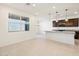 A kitchen island with a granite countertop anchors this modern, open kitchen design at 16032 W Desert Hollow Dr, Surprise, AZ 85387