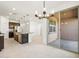 This modern kitchen offers sleek dark cabinets, an island with granite, and stainless steel appliances at 16032 W Desert Hollow Dr, Surprise, AZ 85387