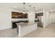 This modern kitchen features a granite island, dark wood cabinets, and stainless steel appliances at 16032 W Desert Hollow Dr, Surprise, AZ 85387