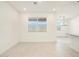 A bright living area offers ample space and tile flooring adjacent to dining room at 16032 W Desert Hollow Dr, Surprise, AZ 85387