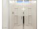 Modern shower with glass door and white tiled walls at 16032 W Desert Hollow Dr, Surprise, AZ 85387