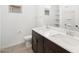 Modern bathroom featuring dual sinks, a dark wood cabinet, and a large mirror at 16066 W Prickly Pear Trl, Surprise, AZ 85387