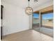 Bright dining room with wood-look tile floors and sliding glass doors to the backyard at 16066 W Prickly Pear Trl, Surprise, AZ 85387