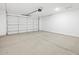 A clean, well-lit two car garage with a modern garage door opener at 16066 W Prickly Pear Trl, Surprise, AZ 85387