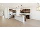 Modern kitchen features a large island, stainless steel appliances, and dark wood cabinetry at 16066 W Prickly Pear Trl, Surprise, AZ 85387