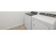 Laundry room featuring new, white, side-by-side, Whirlpool washer and dryer at 16066 W Prickly Pear Trl, Surprise, AZ 85387