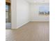 Living room with white walls, wood-look tile flooring and a large sliding glass door at 16066 W Prickly Pear Trl, Surprise, AZ 85387