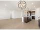Open-concept living room with a modern chandelier and a view of the kitchen at 16066 W Prickly Pear Trl, Surprise, AZ 85387