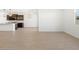 Open floorplan living room with light wood-look tile and natural light from windows at 16066 W Prickly Pear Trl, Surprise, AZ 85387