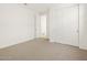 Bedroom with carpet, white trim, and a closet with sliding doors at 16072 W Prickly Pear Trl, Surprise, AZ 85387