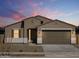 Inviting exterior view of a single-story home featuring neutral colors and a two-car garage at 16072 W Prickly Pear Trl, Surprise, AZ 85387
