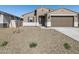 Inviting single-story home with neutral exterior, desert landscaping, and a two-car garage at 16072 W Prickly Pear Trl, Surprise, AZ 85387