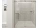 Modern bathroom shower with tiled walls and glass doors for a luxurious spa-like experience at 16072 W Prickly Pear Trl, Surprise, AZ 85387
