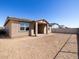 A backyard with dirt ready for landscaping, with a covered patio attached to the home at 16081 W Desert Spoon Dr, Surprise, AZ 85387