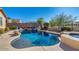 Stunning kidney-shaped pool, waterfall, and built-in spa at 17939 W Lavender Ln, Goodyear, AZ 85338