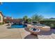 Resort style backyard oasis with a pool and fire pit at 17939 W Lavender Ln, Goodyear, AZ 85338