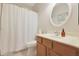 Clean bathroom with wood vanity, shower/tub combo, and white tile at 2688 N 137Th Ave, Goodyear, AZ 85395