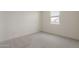 Empty bedroom featuring neutral walls and carpet with bright natural light from a window at 3247 W Garnet St, San Tan Valley, AZ 85144