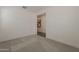Bright bedroom featuring neutral walls, carpet, and a clear view into the hall at 3247 W Garnet St, San Tan Valley, AZ 85144
