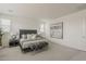 Modern bedroom featuring a stylish bed with plush pillows, contemporary artwork, and neutral tones at 3247 W Garnet St, San Tan Valley, AZ 85144