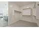 Walk-in closet with minimalist design, featuring white walls, neutral carpet, and simple hanging racks at 3247 W Garnet St, San Tan Valley, AZ 85144