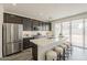 Modern kitchen with stainless steel appliances, quartz counters, and a large island with bar seating at 3247 W Garnet St, San Tan Valley, AZ 85144