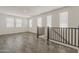Bright and open loft area with neutral tones, tile flooring, and multiple windows at 3247 W Garnet St, San Tan Valley, AZ 85144