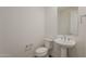 Clean powder room with a pedestal sink, toilet, and modern fixtures at 3247 W Garnet St, San Tan Valley, AZ 85144