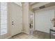 Bright foyer featuring a tiled floor, front door with glass accent, and a view into the bathroom at 4202 E Broadway Rd # 132, Mesa, AZ 85206