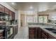 Bright kitchen boasts modern appliances and a breakfast nook with backyard views at 4202 E Broadway Rd # 132, Mesa, AZ 85206