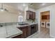 Kitchen featuring dark cabinets, tile countertops, and a view of the laundry room with washer and dryer at 4202 E Broadway Rd # 132, Mesa, AZ 85206
