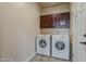 Convenient laundry room with a washer, dryer, and built-in cabinetry at 4202 E Broadway Rd # 132, Mesa, AZ 85206
