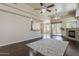 Open-concept living room featuring hardwood floors, ceiling fans, a fireplace, and patio access at 4202 E Broadway Rd # 132, Mesa, AZ 85206