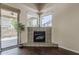 Cozy living room with a corner fireplace, hardwood floors, and sliding glass door access to the patio at 4202 E Broadway Rd # 132, Mesa, AZ 85206
