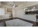 Spacious living room featuring hardwood floors, fireplace, ceiling fans, and an open layout to the kitchen at 4202 E Broadway Rd # 132, Mesa, AZ 85206