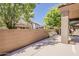 Cozy patio area with chairs, a beautiful plant, and shade provided by mature trees at 4202 E Broadway Rd # 132, Mesa, AZ 85206