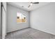 Bright bedroom with carpeted floor, ceiling fan, and window at 10605 E Monterey Ave, Mesa, AZ 85209