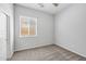 Simple bedroom with carpet, window, and door at 10605 E Monterey Ave, Mesa, AZ 85209