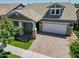 Beautiful home exterior with stone accents and a 2-car garage at 10605 E Monterey Ave, Mesa, AZ 85209