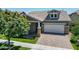 Front view of a craftsman style home with a 2 car garage at 10605 E Monterey Ave, Mesa, AZ 85209