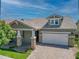 Stunning curb appeal with stone accents, a 2-car garage, and a manicured lawn at 10605 E Monterey Ave, Mesa, AZ 85209