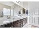 Bathroom with double vanity, large mirror, and glass shower at 14953 W Cortez St, Surprise, AZ 85379