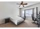 Bright bedroom with a queen bed, large window, and ceiling fan at 14953 W Cortez St, Surprise, AZ 85379