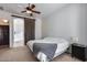 Bedroom with a barn door, nightstand, and ceiling fan at 14953 W Cortez St, Surprise, AZ 85379