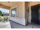 Inviting front porch with black front door and welcoming mat at 14953 W Cortez St, Surprise, AZ 85379