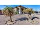 Landscaped front yard with two palm trees and gravel at 14953 W Cortez St, Surprise, AZ 85379