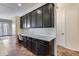 Kitchen features dark cabinetry and a built-in desk at 14953 W Cortez St, Surprise, AZ 85379