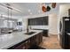 Modern kitchen with dark cabinets and a large island with sink at 14953 W Cortez St, Surprise, AZ 85379