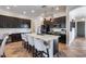 Modern kitchen with dark cabinets, large island, and stainless steel appliances at 14953 W Cortez St, Surprise, AZ 85379